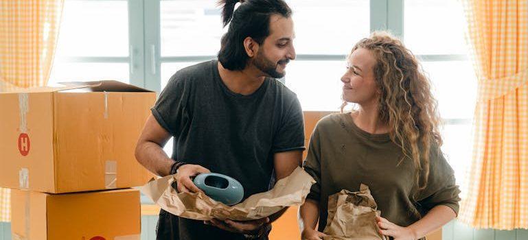 A couple packing moving boxes.